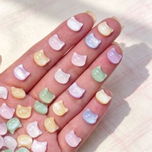 Close-up product view of colorful 3D cat charms for nail art and DIY crafts