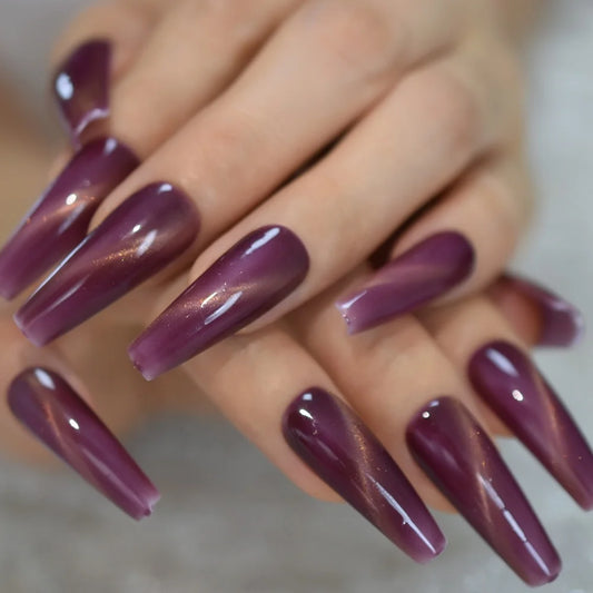 Purple cat eye press on nails in a long coffin shape with glossy galaxy shimmer full cover finish