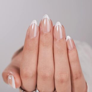 Close-up view of the almond shape and classic white French tip design