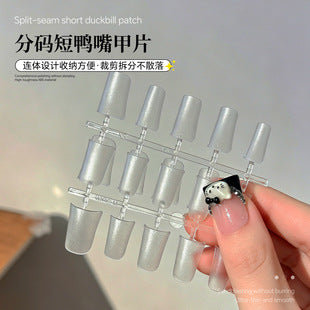 Transparent false nail tips showing the natural short square shape and lightweight style