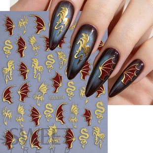 Close-up of self-adhesive Halloween dragon nail decal sheet with metallic gradient detail